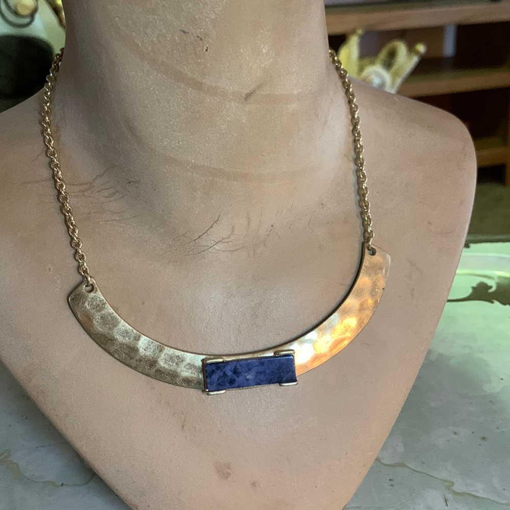 Gold collar with blue/black speckled rectangle center piece.